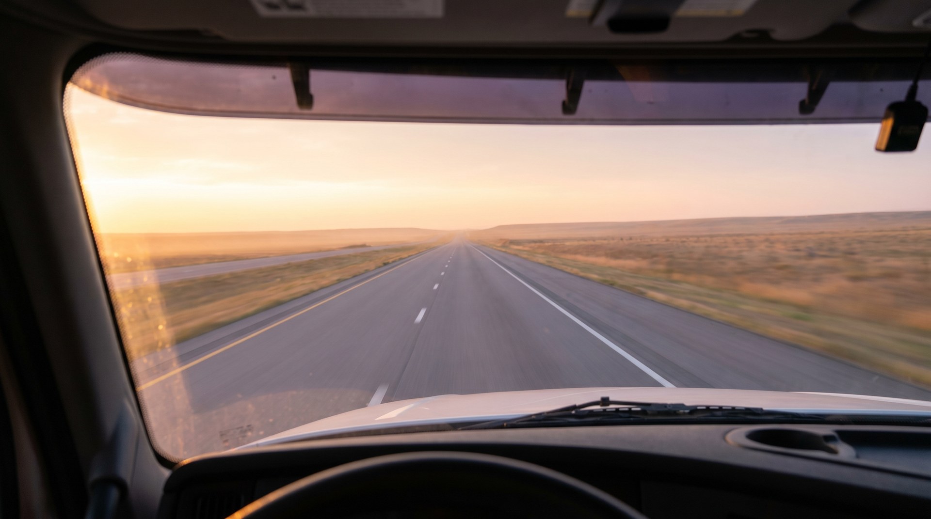 Highway view through truck windshield